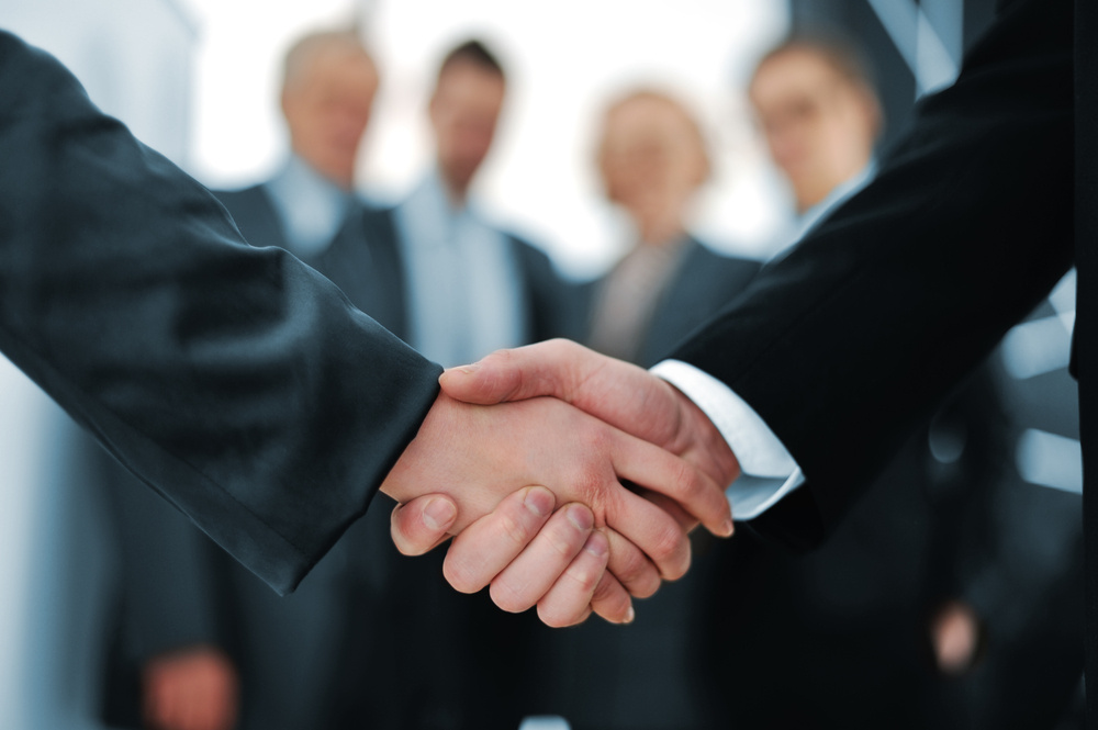 Handshake in front of business people